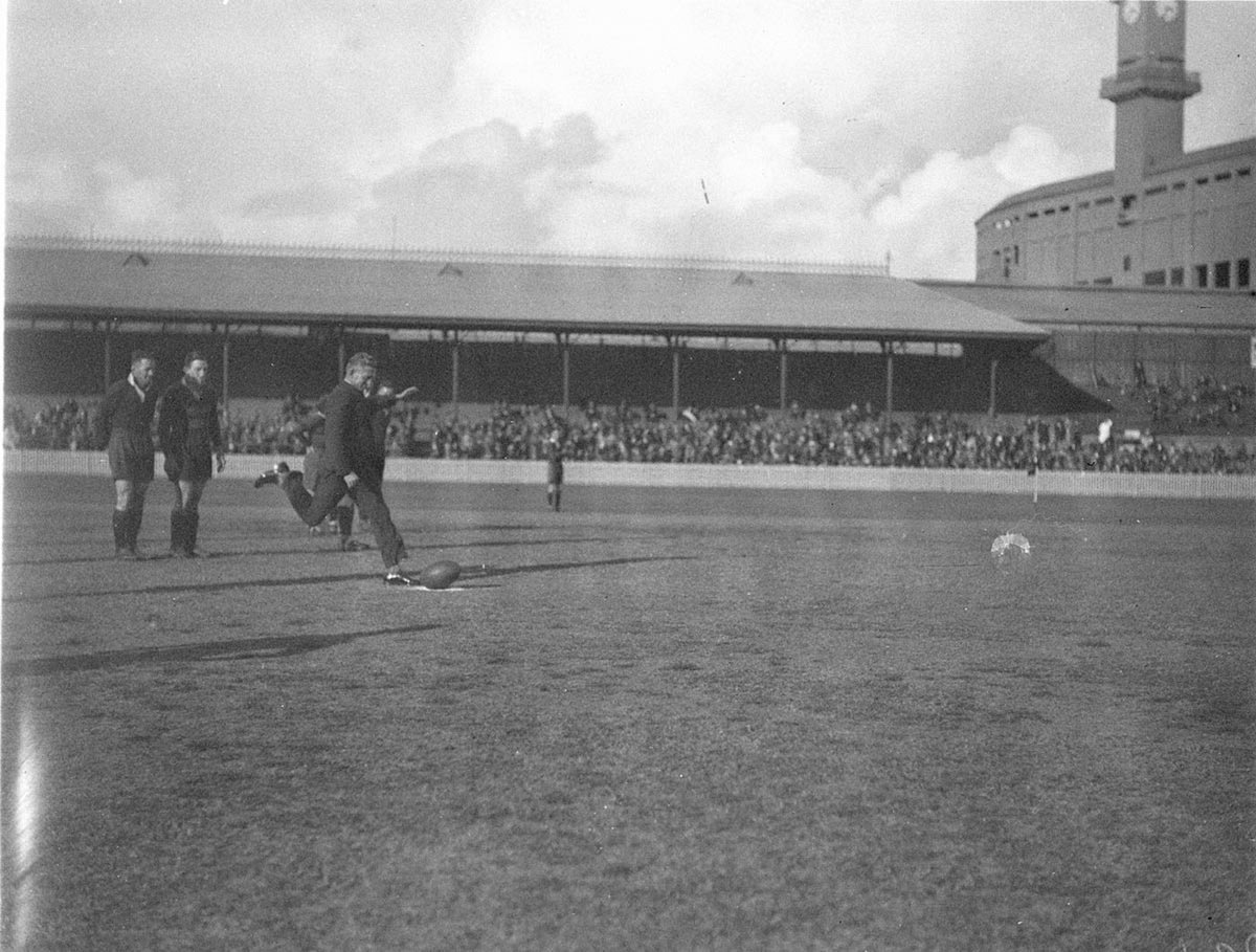 VIP Bennie Wearing in a suit kicks off to start game (1930s)