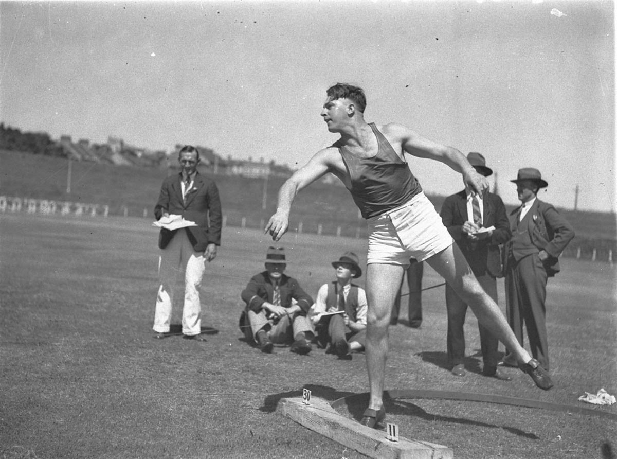 WPlummer wins the 16 lb shotput 45 feet 5 34 inches (1935)