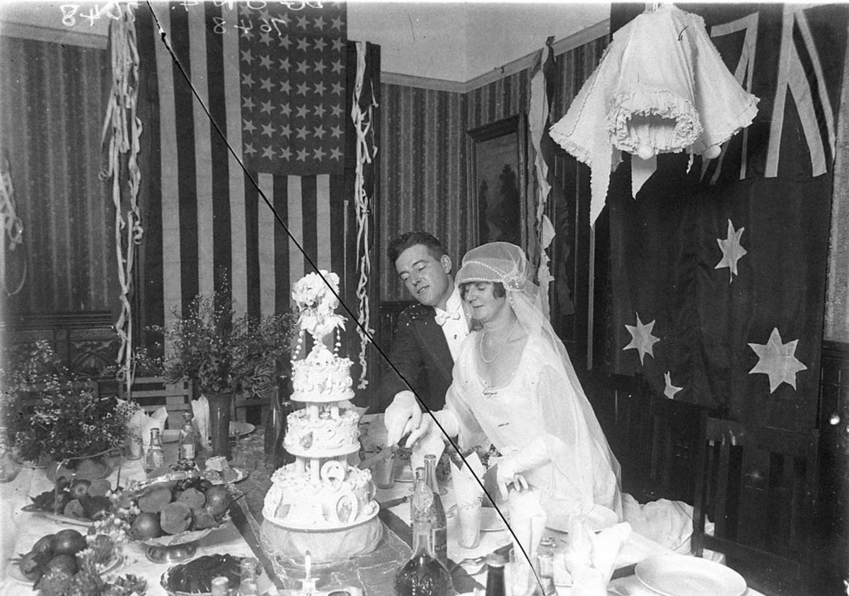 Wedding reception cutting the cake (1920s)