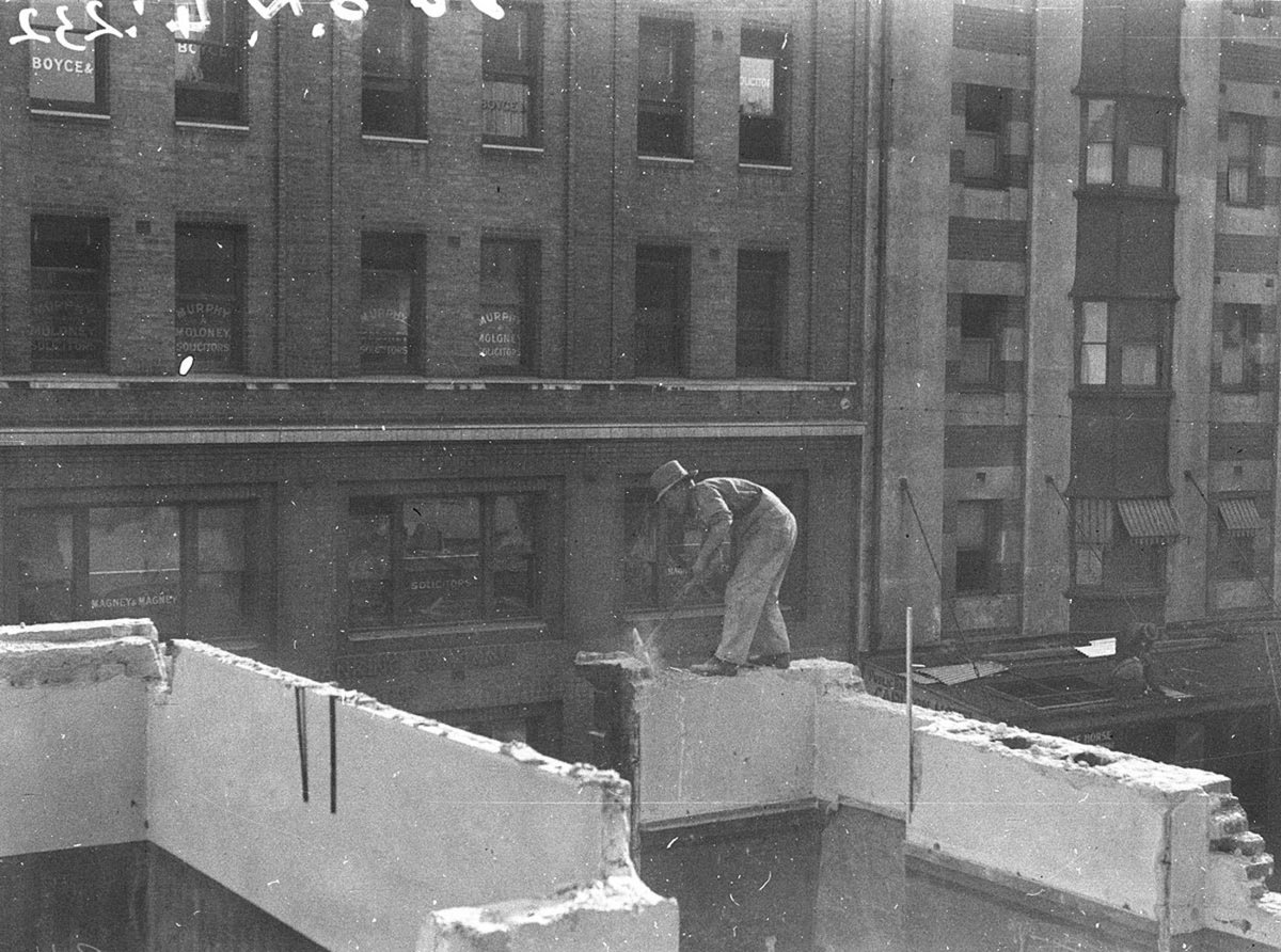 Widening Elizabeth Street Workman demolishing building opposite legal chambers, Sydney city centre (1934)