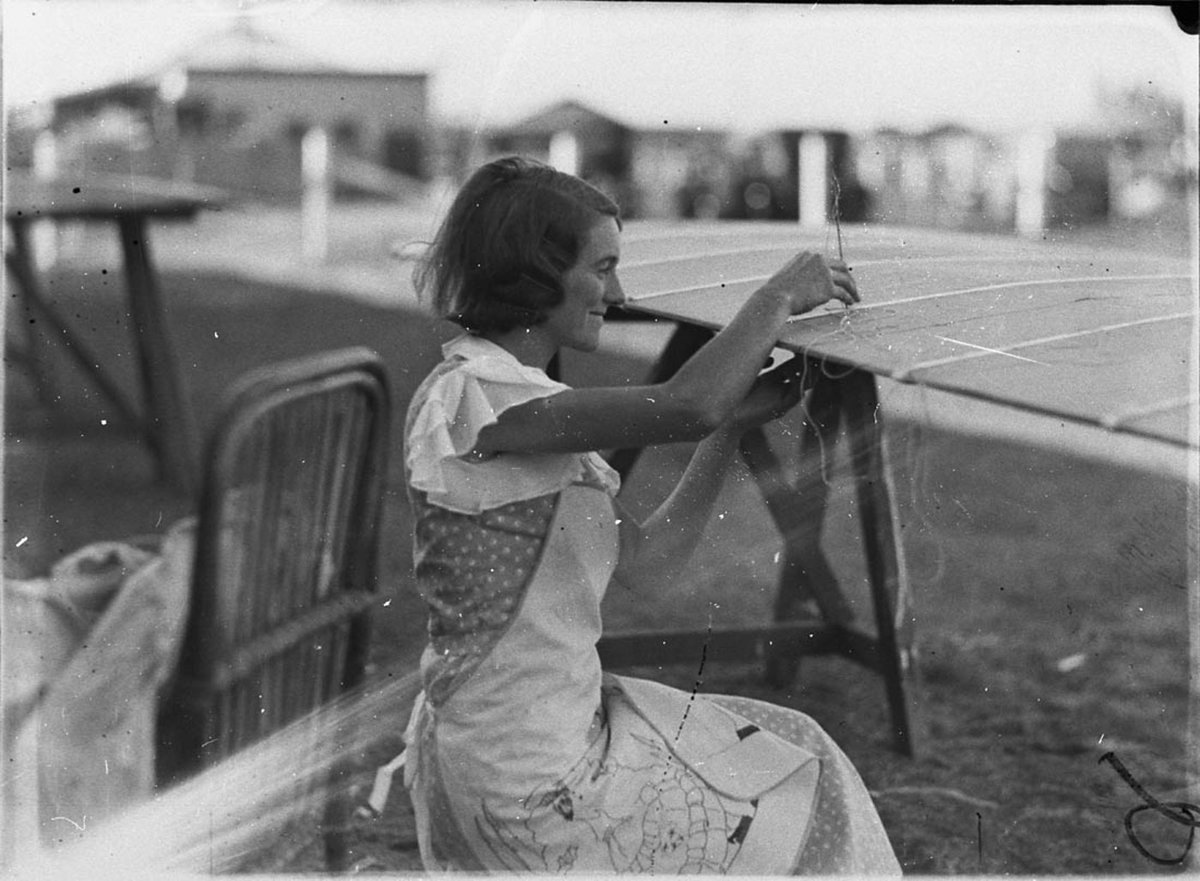 Woman fabric worker stitching linen onto aircraft wings (1930s)