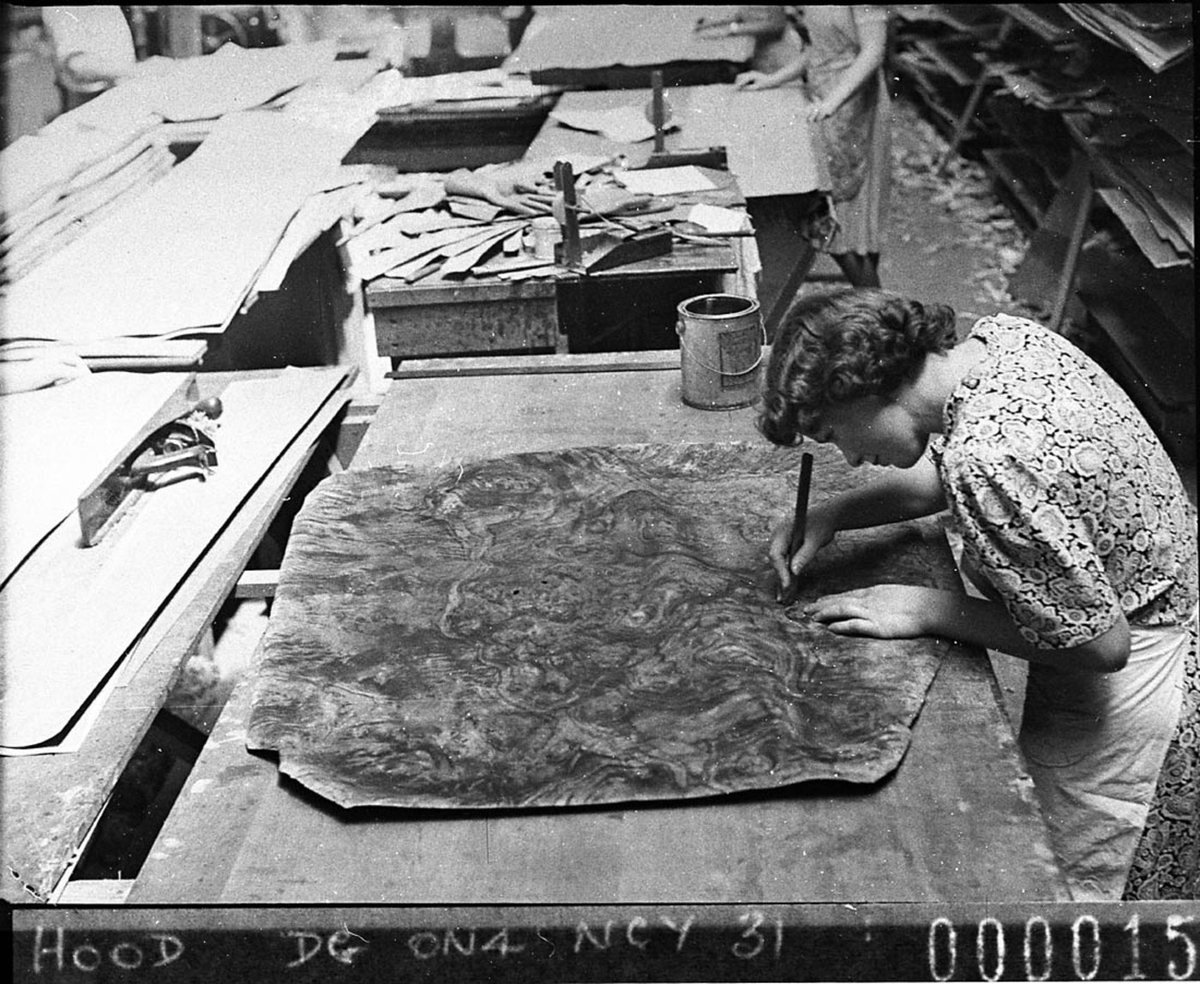 Woman selecting and assembling artistic patterns of veneer for art furniture use Frederick Roses factory at Mascot taken for Timber Journal (1940)
