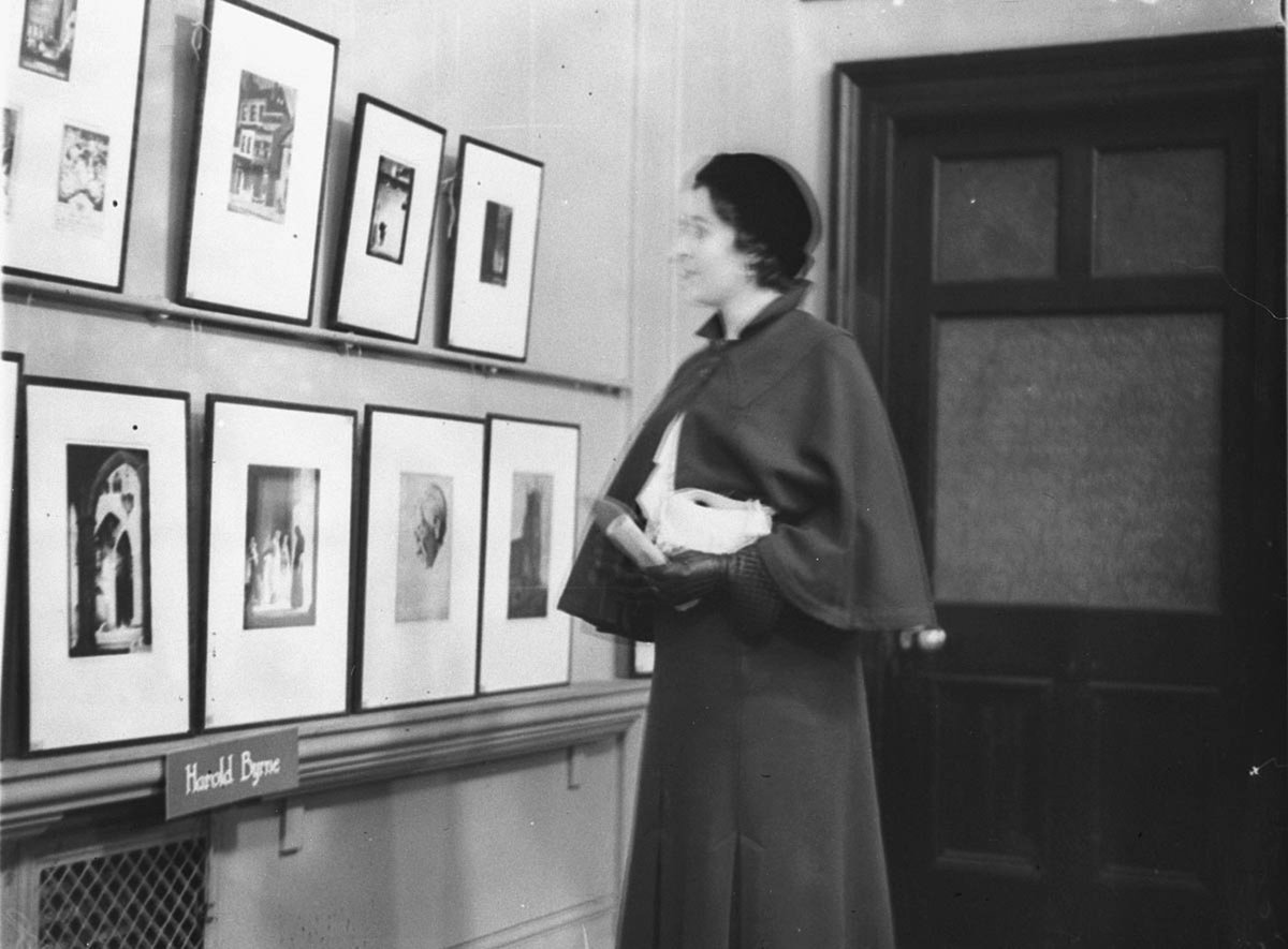Woman viewing works of art at Art Gallery (1930s)