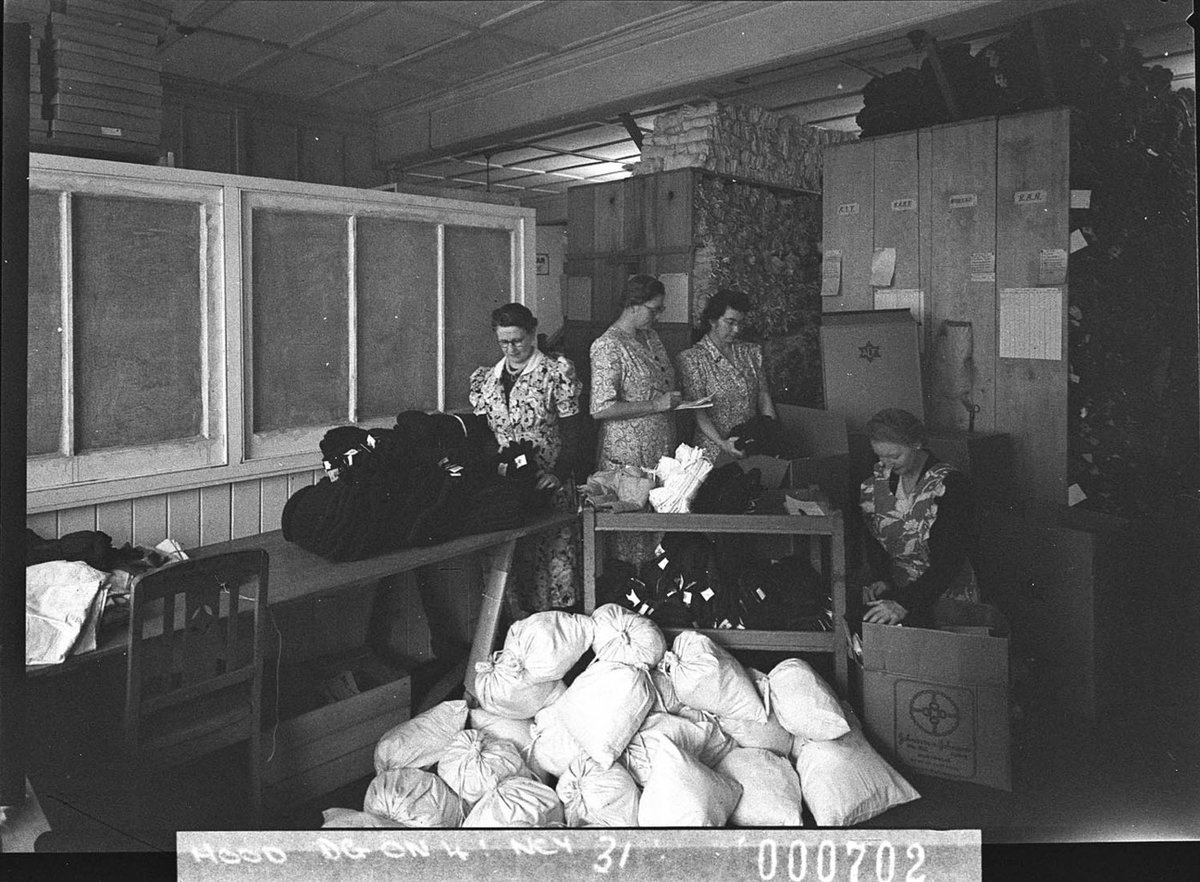 Women volunteers packing bags with clothes taken for Australian Comforts Fund, Parramatta (1944)
