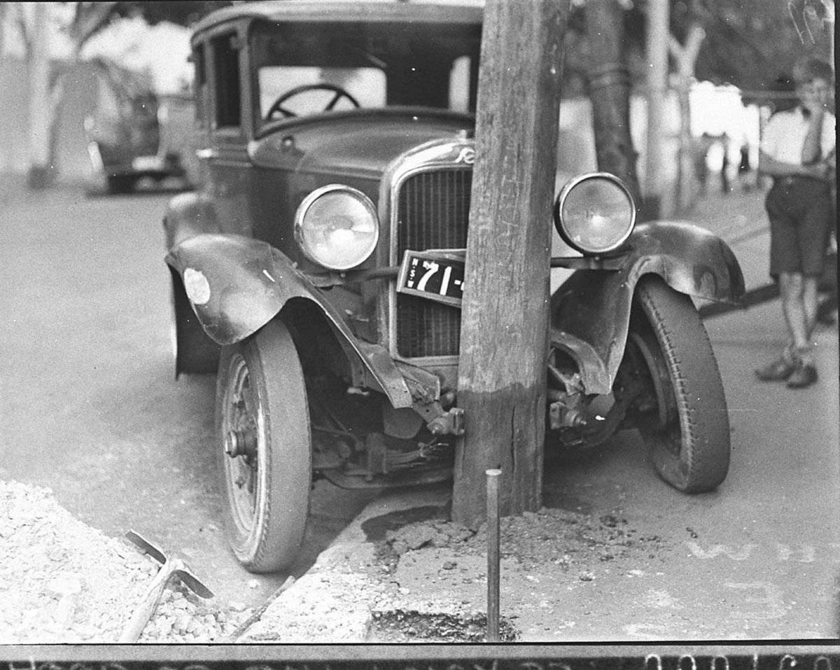 Workmen chipping away concrete to free the vehicle, Sydney (1935)