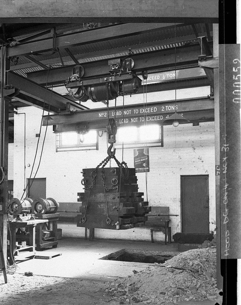 Workshop scene showing two ton electric hoist doing a lift Wartime sign Dont help the black market (1944)