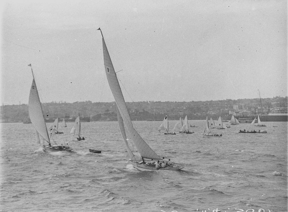 Yachts passing in foreground (1930s)