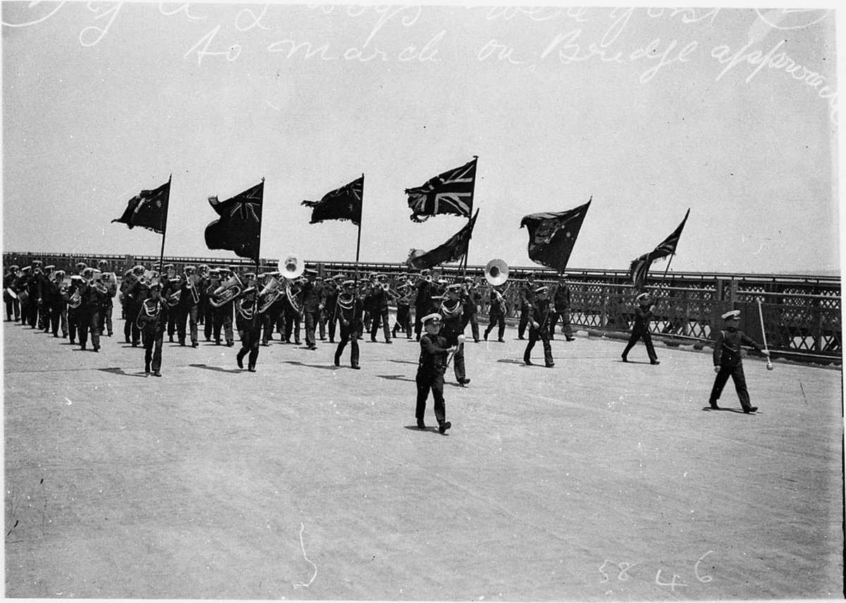 Young Australia League YAL Bandsmen play as the last section of the deck on north side is being set in place (1931)