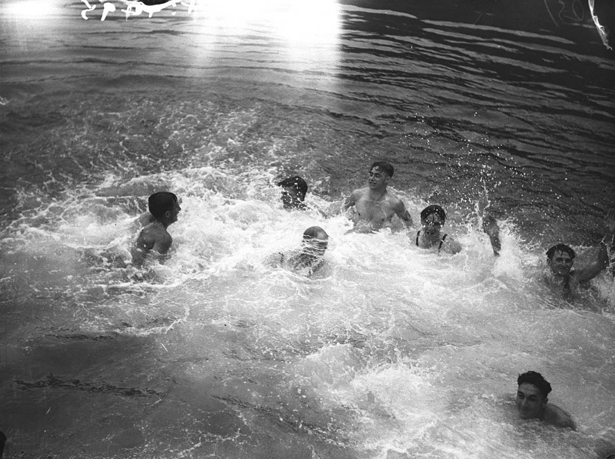 Young men diving into the Harbour at the central wharf Millers Point (1935)