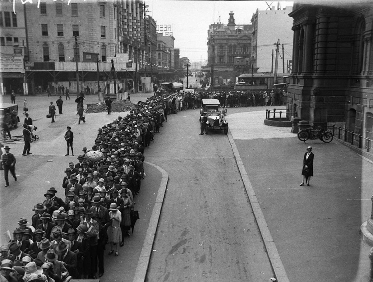 "City railway (underground) was under construction" - election rally queue, Druitt St, with construction in George St including Town Hall Hotel, 1927-1930, by Sam Hood, Sydney city centre (1928)