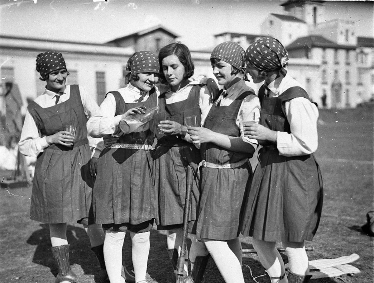 Five schoolgirl hockey players enjoy a glass of lemonade, Sydney University, 192- - photographer Sam hood, Camperdown (1929)