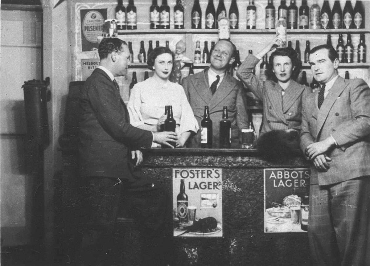 Group around a bar, c. 1930s, by Sam Hood (1880–1940)