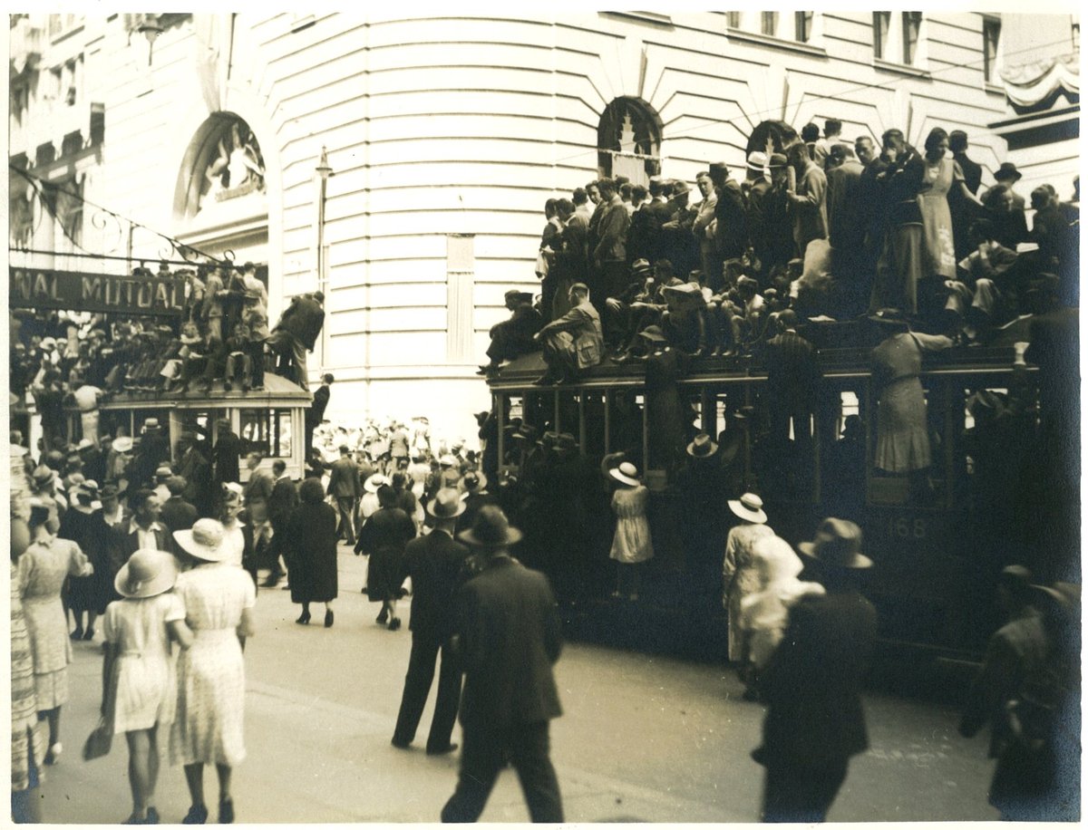 Spectators of the Australian Sesquicentenary parade stand on trams for a better view, George Street, Sydney, 26 January 1938 - photographer Donald Charles Boulton Maclurcan, Sydney city centre