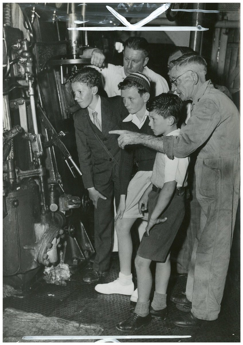 Chief officer George Todd, right, and his asistant Bob Luther explain the engine to John Rae, Jim Swan and James Wilton, on the ocean cruise to Broken Bay, South Steyne, December 1953 - Australian, Sydney