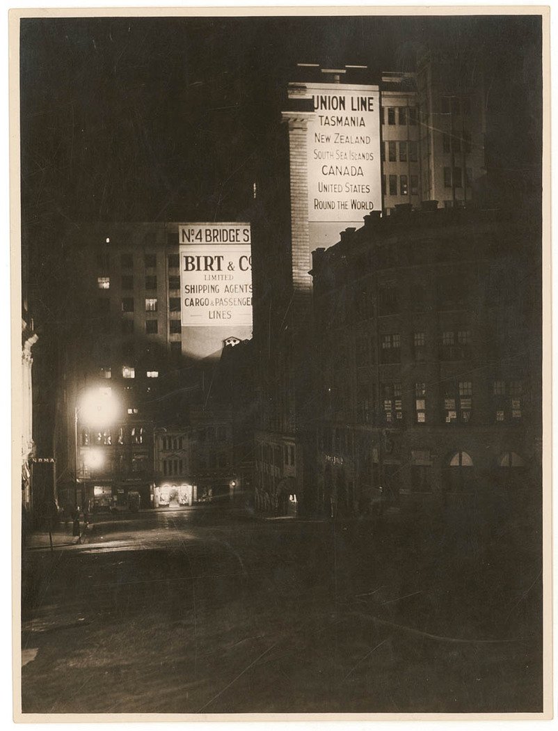 Looking east down Grosvenor Street, at night, with no. 4 Bridge street and the Union Line Building lit up, n.d. by Sam Hood, Sydney (1930)