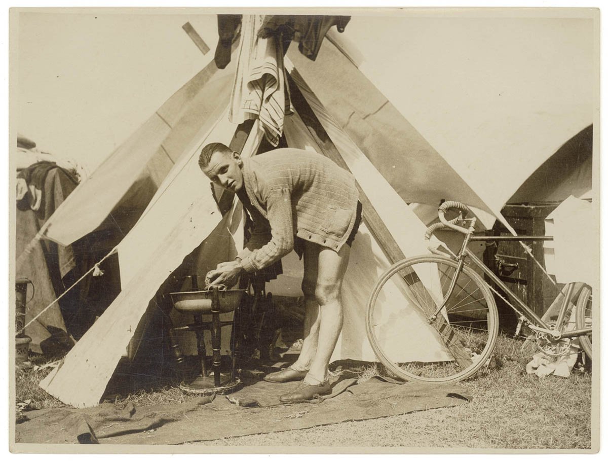 Cyclists camp during a road race, by Sam Hood (1936)