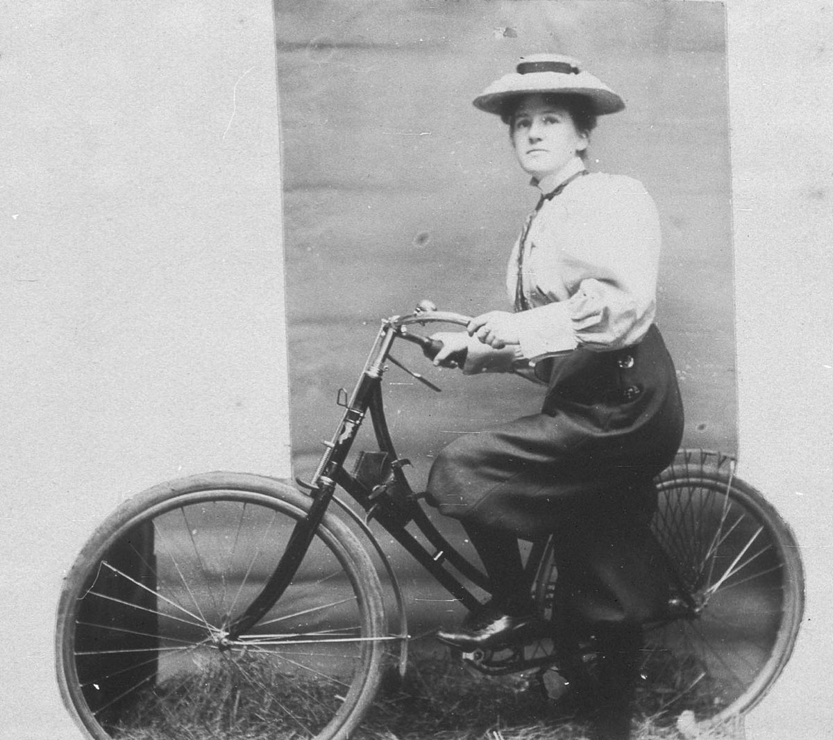 Annie Dawson Wallace with her bicycle. NB- Annie is wearing trousers - Sydney, NSW, 1899