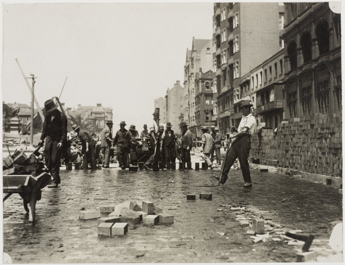 Blocking Macquarie Street with woodblocks and tar, opposite Mitchell Library, 10 October 1925 - photograph by the Labor Daily, Sydney city centre