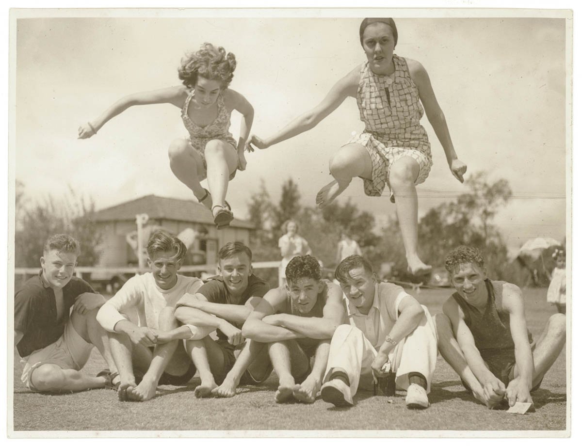 Girls jump over boys seated on a sportsground, c. 1930s, by Sam Hood, Sydney