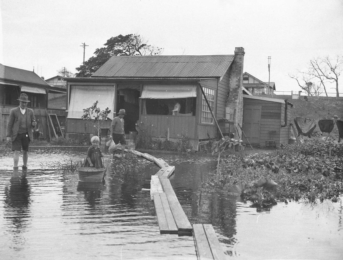 Narrabeen flooding; duck-boards for access, April 1927, by Sam Hood