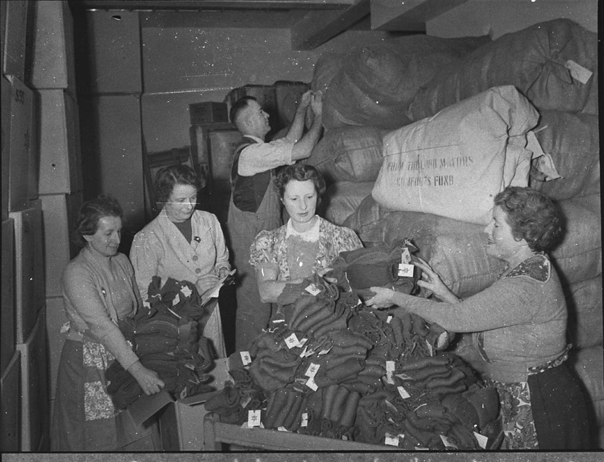 Women volunteer workers doing up clothing parcels at the ACF rooms (taken for Australian Comforts Fund), Sydney, 1944 - photographer Sam Hood