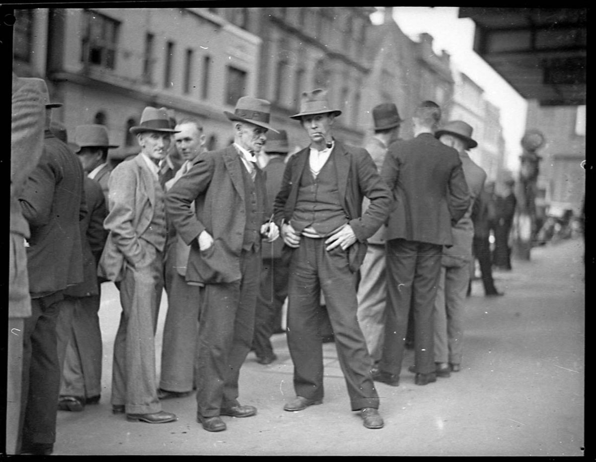 Unemployed carpenters in Phillip Street wait to hear succesful applicant for one position, 17 June 1935, by Sam Hood, Sydney city centre