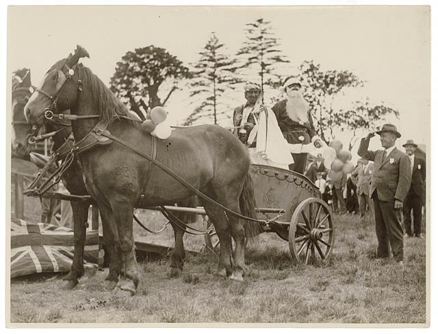 Santa arrives in a chariot driven by a "sheik", n.d. - by Sam Hood (1930)