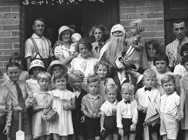 Santa Claus and children at the I.O.O.F. Christmas party, Bexley, 22 Dec 1934 - by Sam Hood