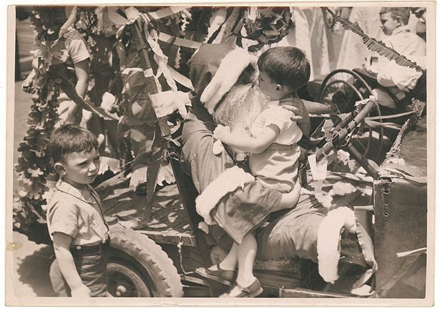Santa in a jalopy, n.d. - by Sam Hood (1935)