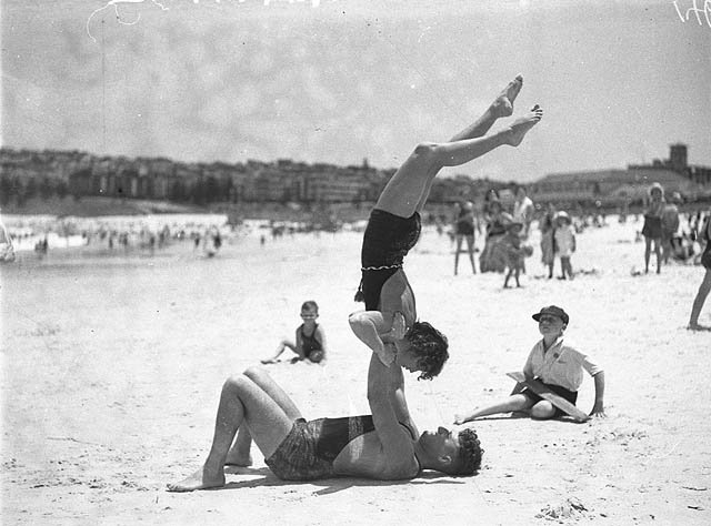 Mr J Prentice and Miss J Howat performing beach acrobatics at Bondi Beach, 2 Jan 1935 - by Ted Hood
