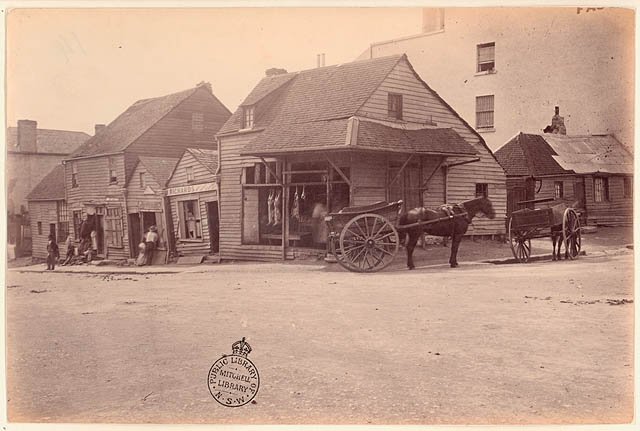 Weatherboard buildings, Market Street, at the corner of Clarence Street, Sydney, (Dec 1875) - by unknown photographer, Sydney city centre