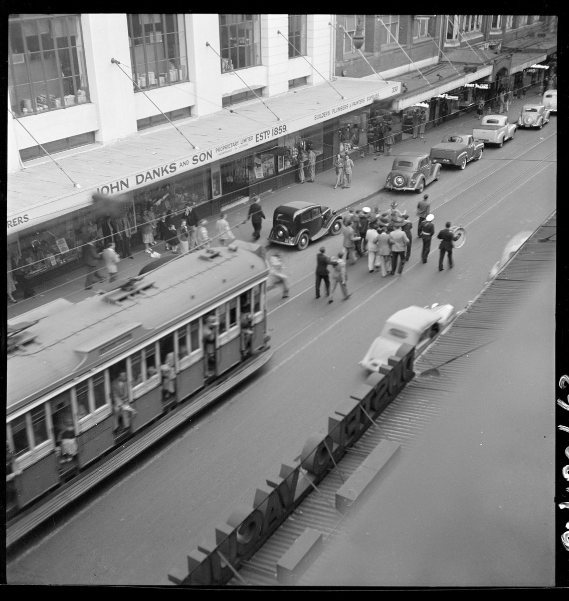 ANZAC Day - celebration drinks, marching down Pitt Street, April 1950, from Series 02- Sydney people & streets, 1948-1950, photographed by Brian Bird, Sydney city centre