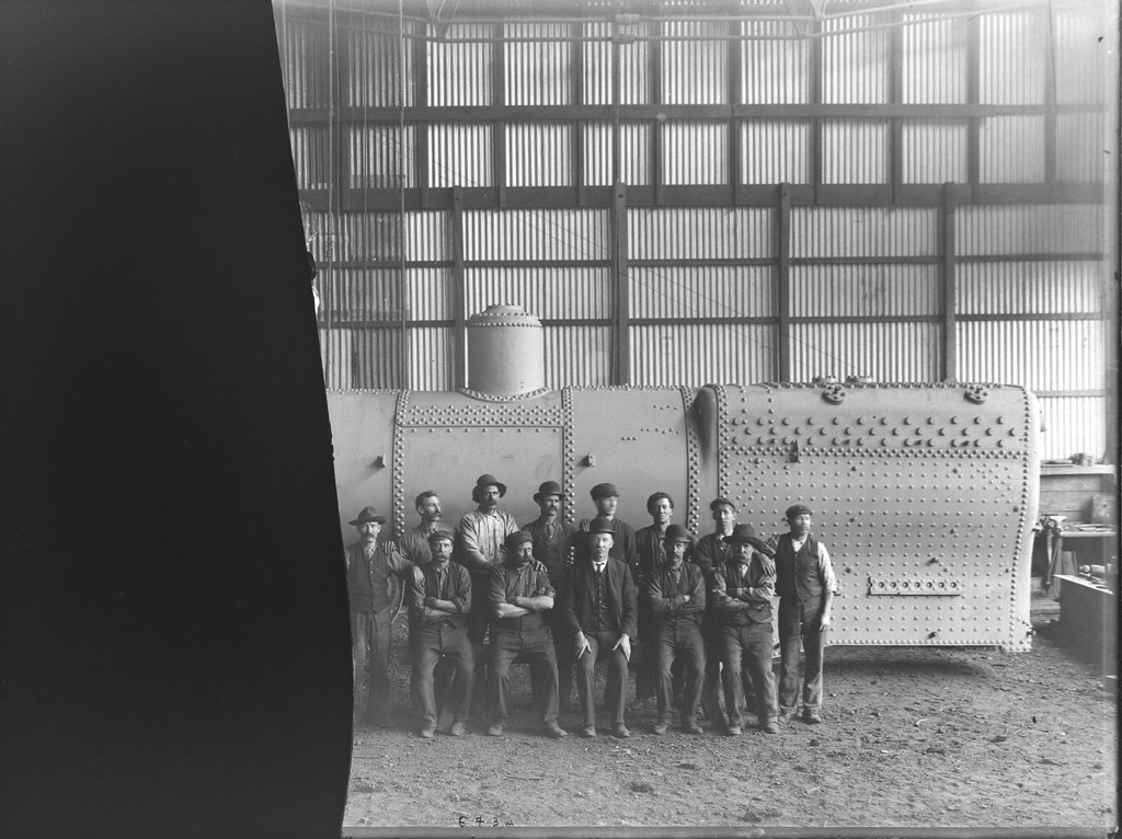 Clyde employees next to railway locomotive boiler (c. 1988)