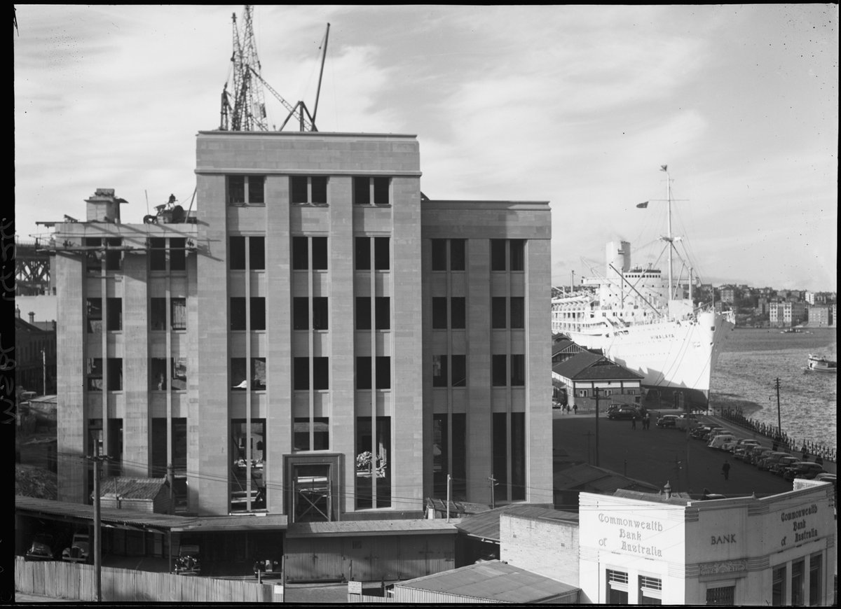 SS HIMALAYA in Sydney Cove with the Ferry Sunris Star passing. The Maritime Services Board building can be seen under construction, Circular Quay (c. 1949)