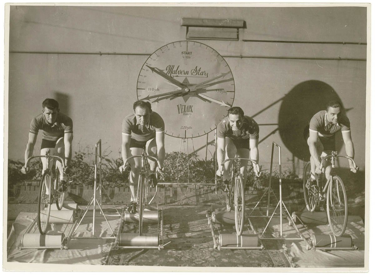 Four cyclists on speed bicycles on rollers time trials to promote Malvern Star- from left, Lennie Rogers, Bill Moritz, - ?, - ?), by Sam hood (1925–40)