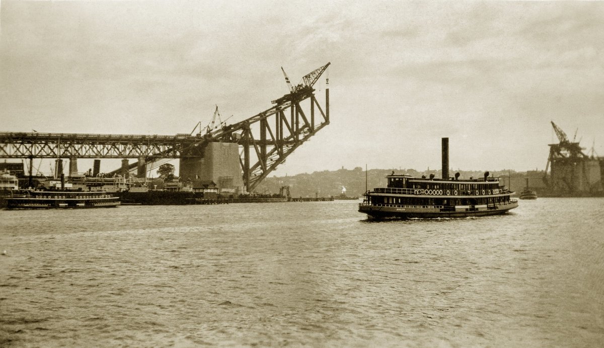 Sydney Ferry KUBU approaches Circular Quay and Harbour Bridge under construction Sept 1929