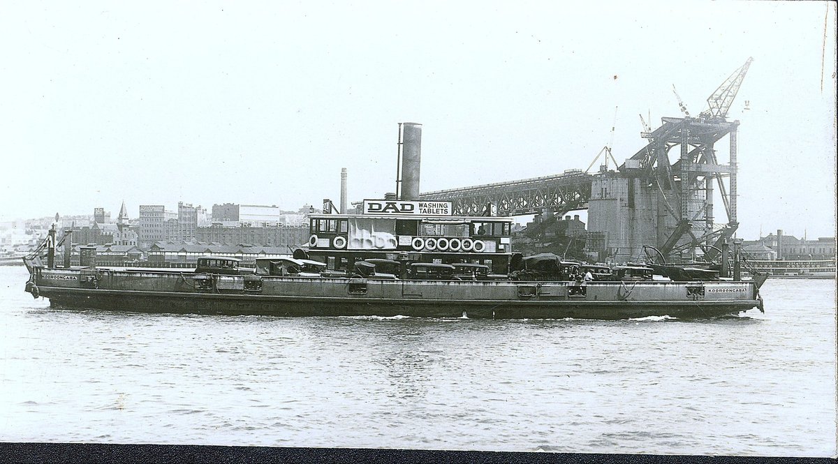 Sydney vehicular ferry KOOROONGABBA passing Sydney Harbour Bridge under construction late 1920s