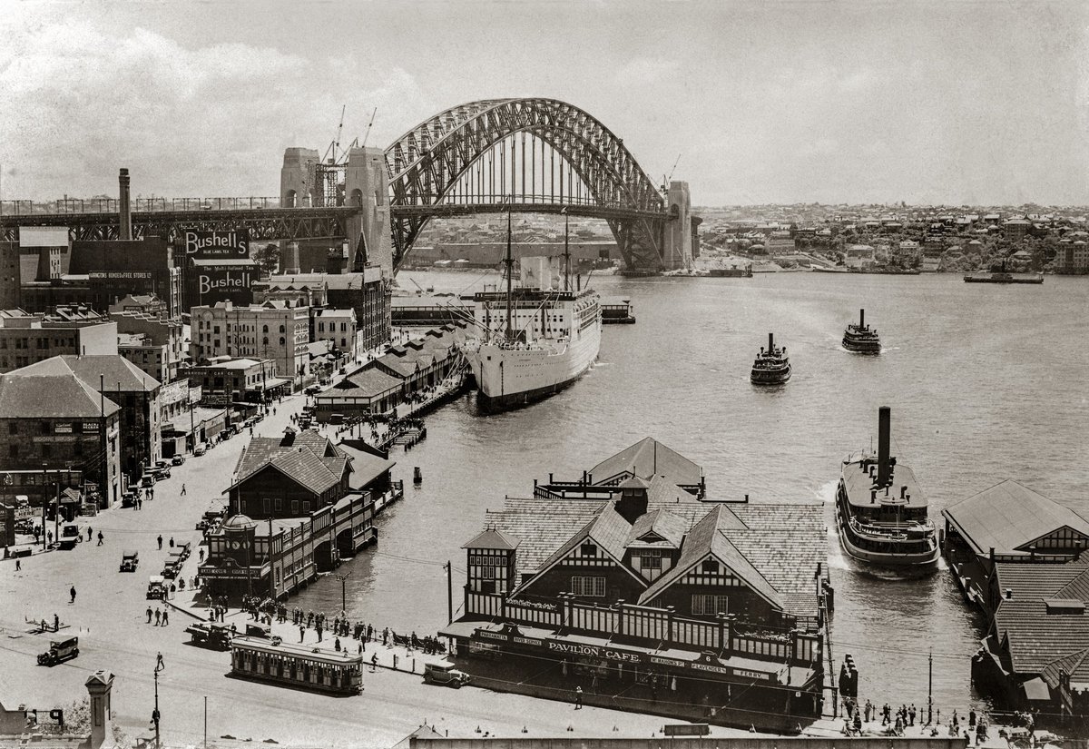 Sydney harbour ferries in Circular Quay with almost complete Sydney Harbour Bridge probably early 1932 or late 1931 (1931–32)