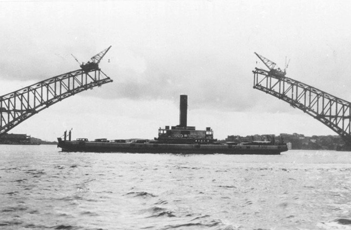 Sydney vehicular ferry KOONDOOLOO in 1929 near Sydney Harbour Bridge under construction