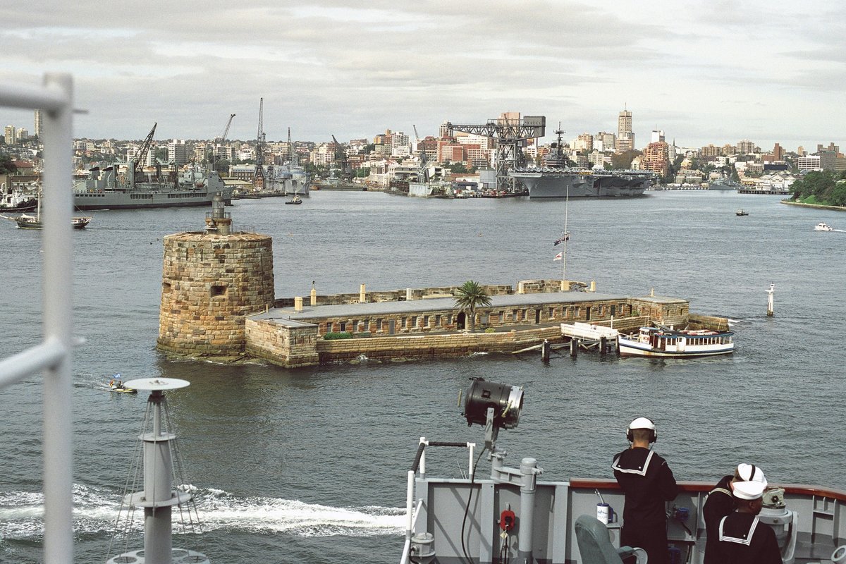 A view of an old coastal defense fort inside Sydney Harbor as seen from the USS BLUE RIDGE (LCC-19). In the background is the Sydney Naval Base with the aircraft carrier USS INDEPEN - DPLA - 67d1f91183407584bb12844a1f4ab5c5, Sydney Harbour (1992)