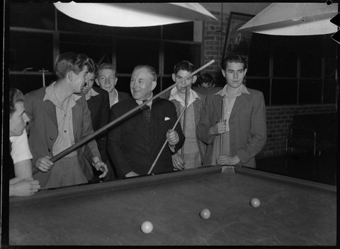 W.A. Crowle playing pool with "Once Upon a Time" boys home residents, 1946