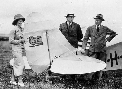 Aviatrix Nancy Bird and her new plane (Leopard Moth) the day before she left for Bourke with the managing director and manager of Vita-Lick Ltd - Sydney, NSW, 1934
