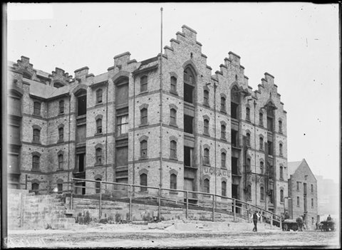 Grafton Bond Store with horse-drawn wagon handling materials, 1923