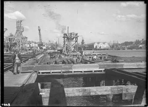 Fitting Out Wharf at Garden Island. The aircraft carrier USS SARATOGA can be seen at the rear of wharf Number 7, Woolloomooloo, 1944