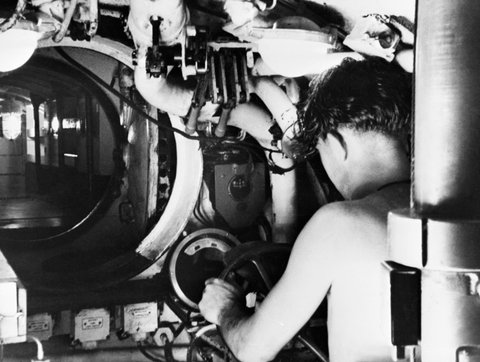 A submariner at the controls of a Royal Navy midget submarine in Sydney, Australia, 1945. A30570