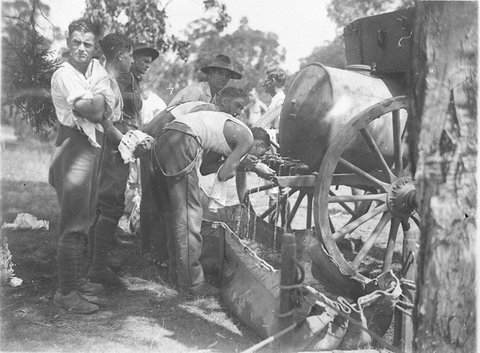 Diggers cooling off from the water limber as they fill the canvas horsetroughs, c. 1932