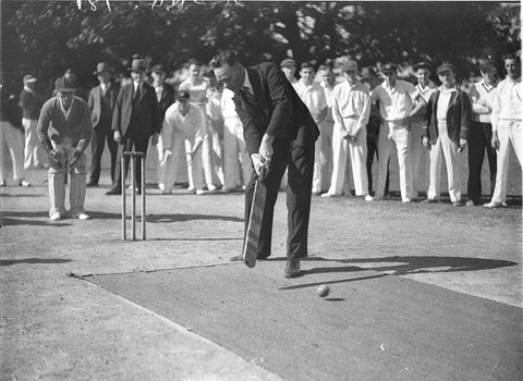 A politician plays the first ball at local cricket match, 1934