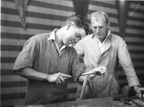 Aircraft fitter filing a bracket at the bench in the construction of the all Australian monoplane Grace Bros, 1934