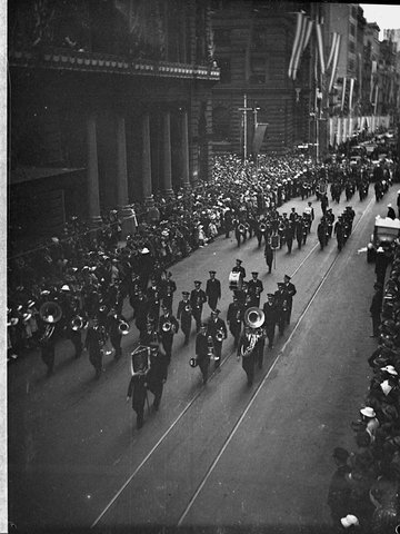 Bands march through streets, 1938