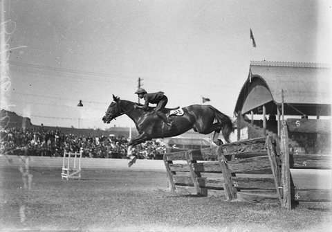 Beryl Perry clears the hurdle in the ladies hunt, 1930s